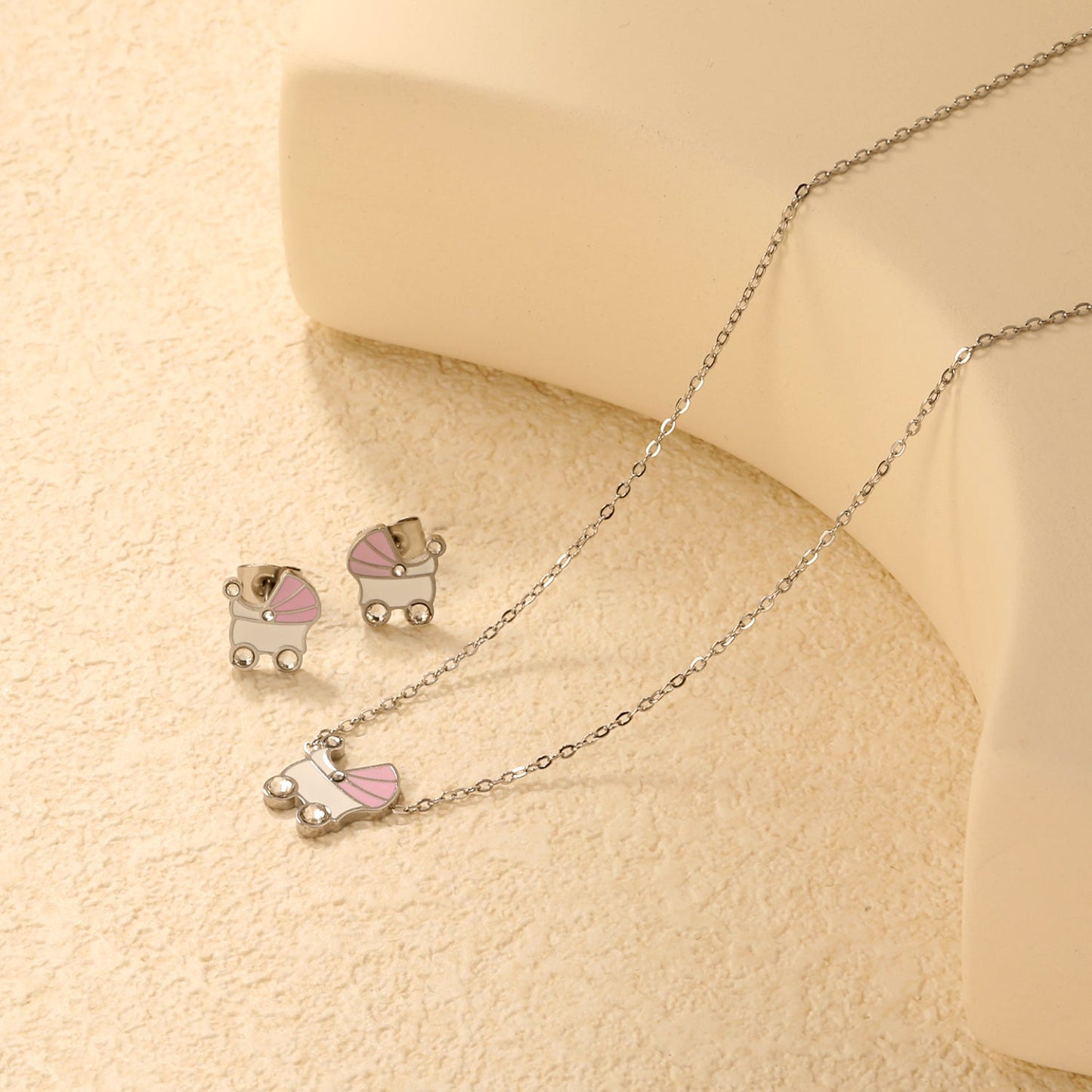 Pink and white rocking bed oil-dripping set with diamonds. Earrings: 9.8 x 10mm. Pendant: 10.5 x 12mm. 0.3mm cross chain 42+5cm + 6mm round pendant. Gold/steel color. asonjewelry