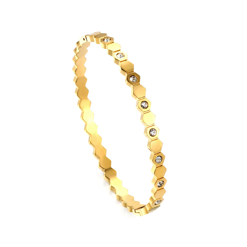 Hard bracelet with diamonds strung together with small gold-colored discs asonjewelry