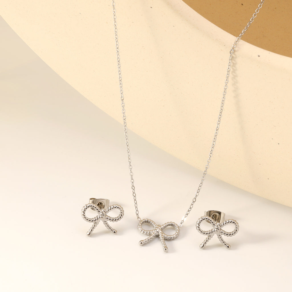 Bow Set Steel Color Earrings:13.2*11.2mm Necklace:13.2*11.2mm0.3 Cross Chain*40+5cm+6mm Round Plaque