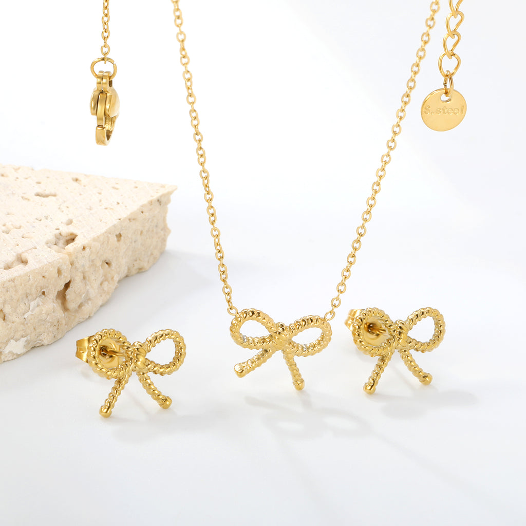 Bow Set Steel Color Earrings:13.2*11.2mm Necklace:13.2*11.2mm0.3 Cross Chain*40+5cm+6mm Round Plaque