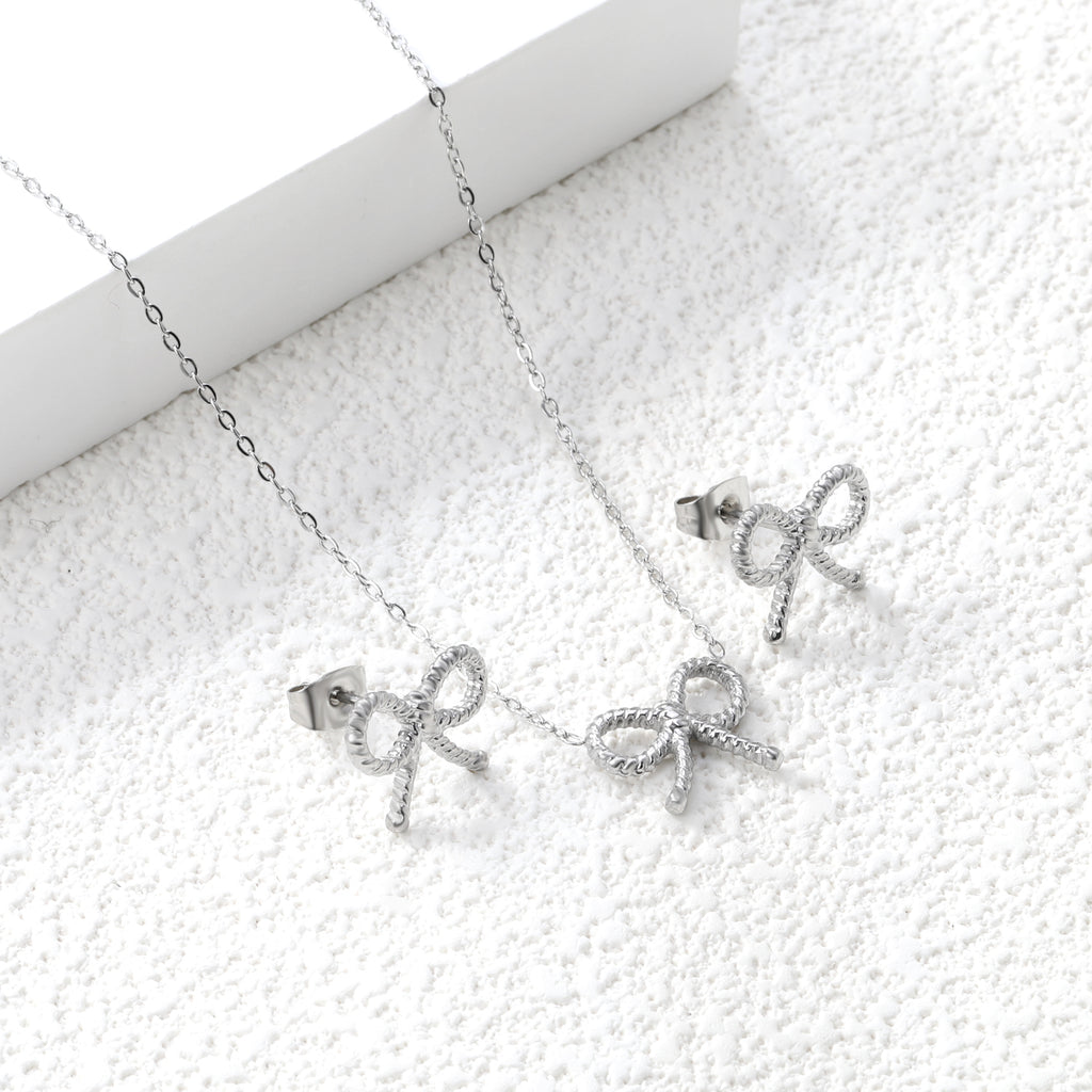 Bow Set Steel Color Earrings:13.2*11.2mm Necklace:13.2*11.2mm0.3 Cross Chain*40+5cm+6mm Round Plaque