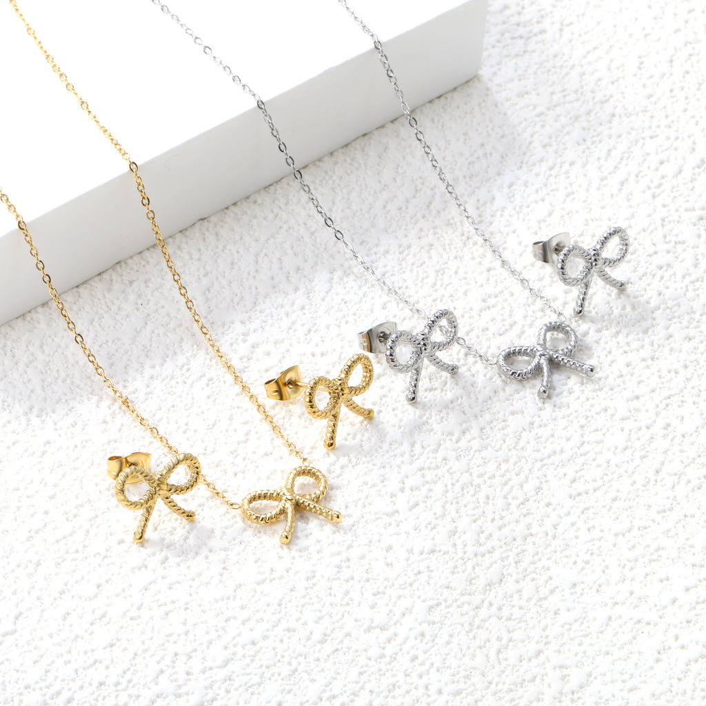 Bow Set Steel Color Earrings:13.2*11.2mm Necklace:13.2*11.2mm0.3 Cross Chain*40+5cm+6mm Round Plaque