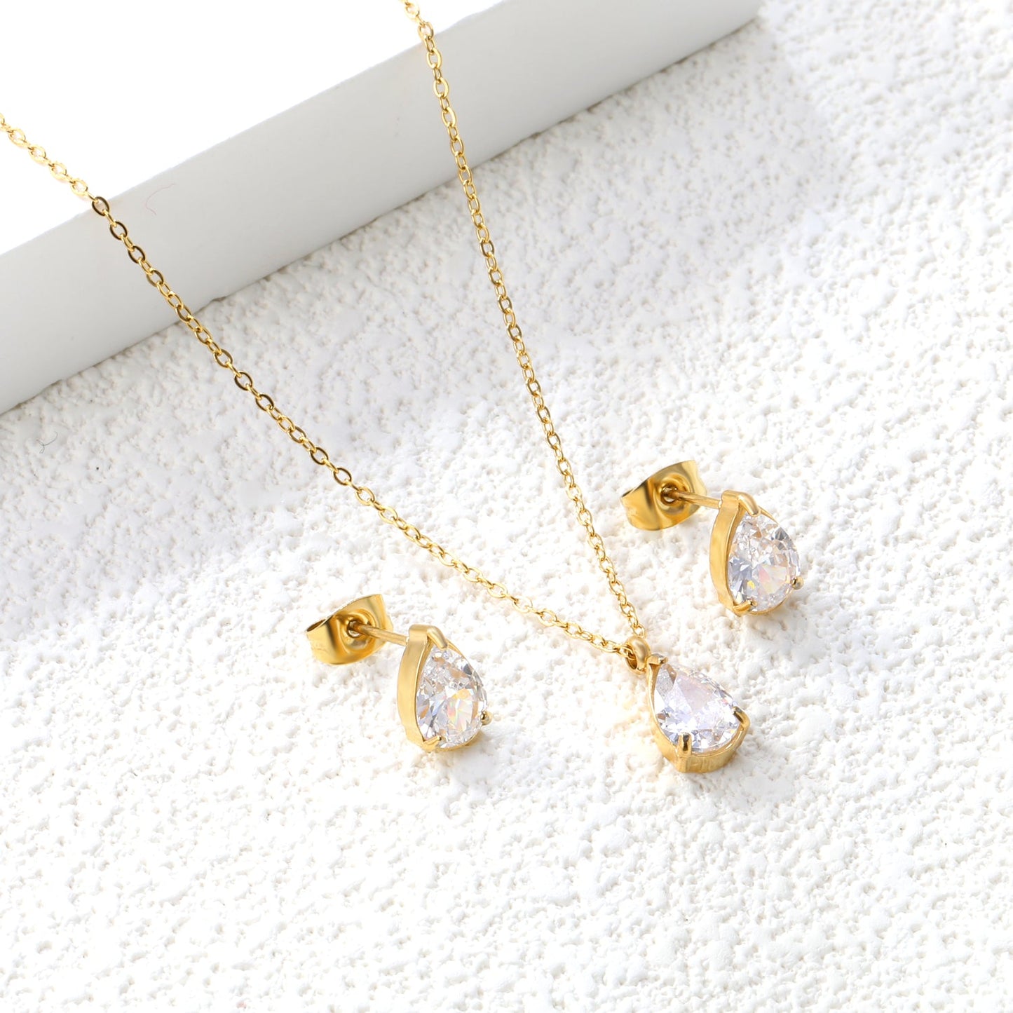 Teardrop white zirconium set Gold-colored earrings:6.1*9.4mm Pendant:6.1*9.4mm 0.3 cross chain*40+5cm+6mm round plaque asonjewelry