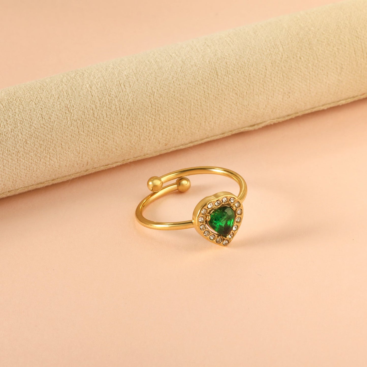 Heart shaped green diamond with small white diamonds ending in an open round bead ring asonjewelry