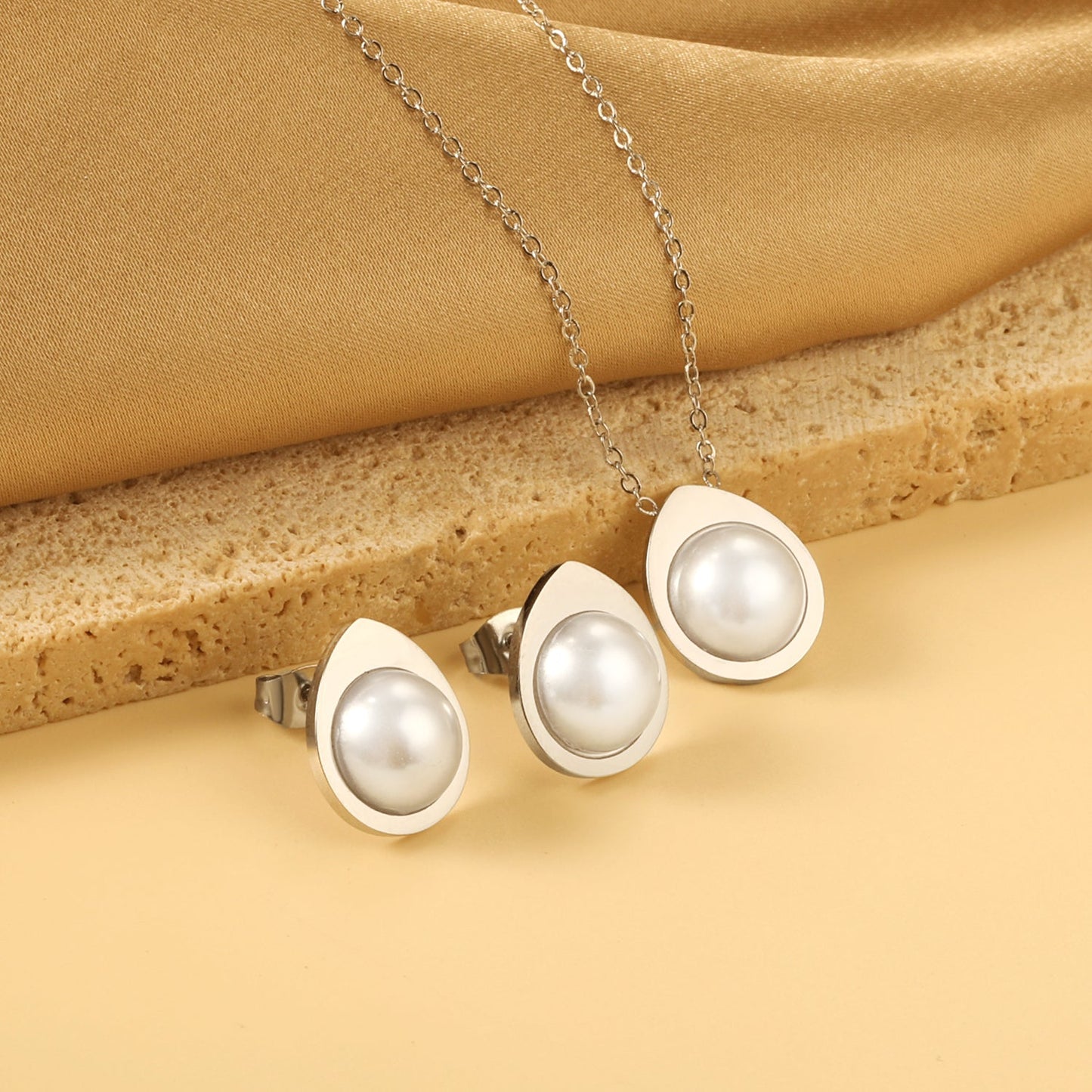 Teardrop shaped jewelry set with half white pearl steel color / gold asonjewelry