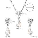 Flower + drop white diamond set Steel / Gold Earrings: 8.3mm flower + 6.2*10mm drop white diamond Pendant: 8.9mm flower + 6.2*10mm drop white diamond 0.3 Cross chain 42+5cm+6mm round plate