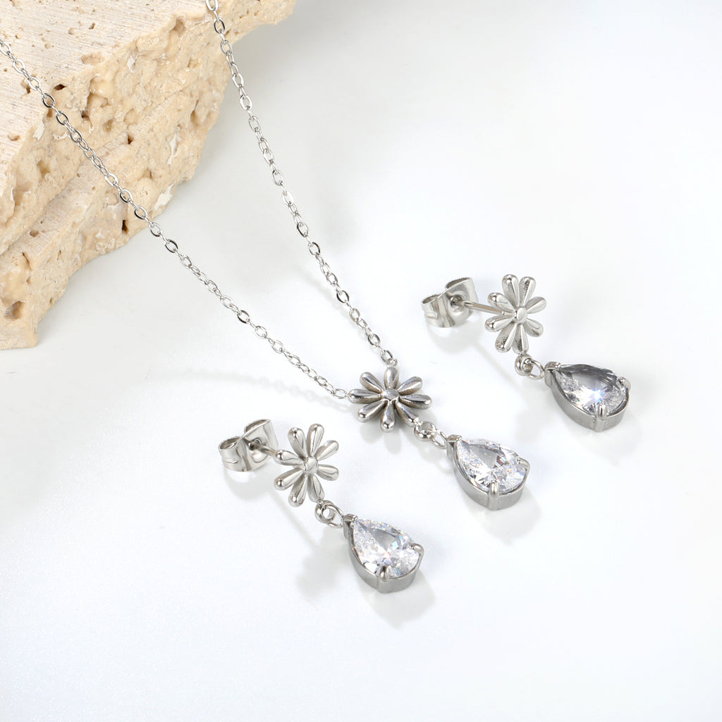 Flower + drop white diamond set Steel / Gold Earrings: 8.3mm flower + 6.2*10mm drop white diamond Pendant: 8.9mm flower + 6.2*10mm drop white diamond 0.3 Cross chain 42+5cm+6mm round plate