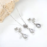 Flower + drop white diamond set Steel / Gold Earrings: 8.3mm flower + 6.2*10mm drop white diamond Pendant: 8.9mm flower + 6.2*10mm drop white diamond 0.3 Cross chain 42+5cm+6mm round plate