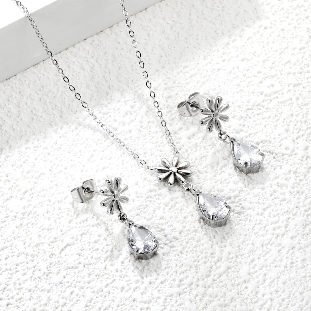 Flower + drop white diamond set Steel / Gold Earrings: 8.3mm flower + 6.2*10mm drop white diamond Pendant: 8.9mm flower + 6.2*10mm drop white diamond 0.3 Cross chain 42+5cm+6mm round plate