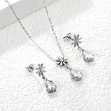 Flower + drop white diamond set Steel / Gold Earrings: 8.3mm flower + 6.2*10mm drop white diamond Pendant: 8.9mm flower + 6.2*10mm drop white diamond 0.3 Cross chain 42+5cm+6mm round plate