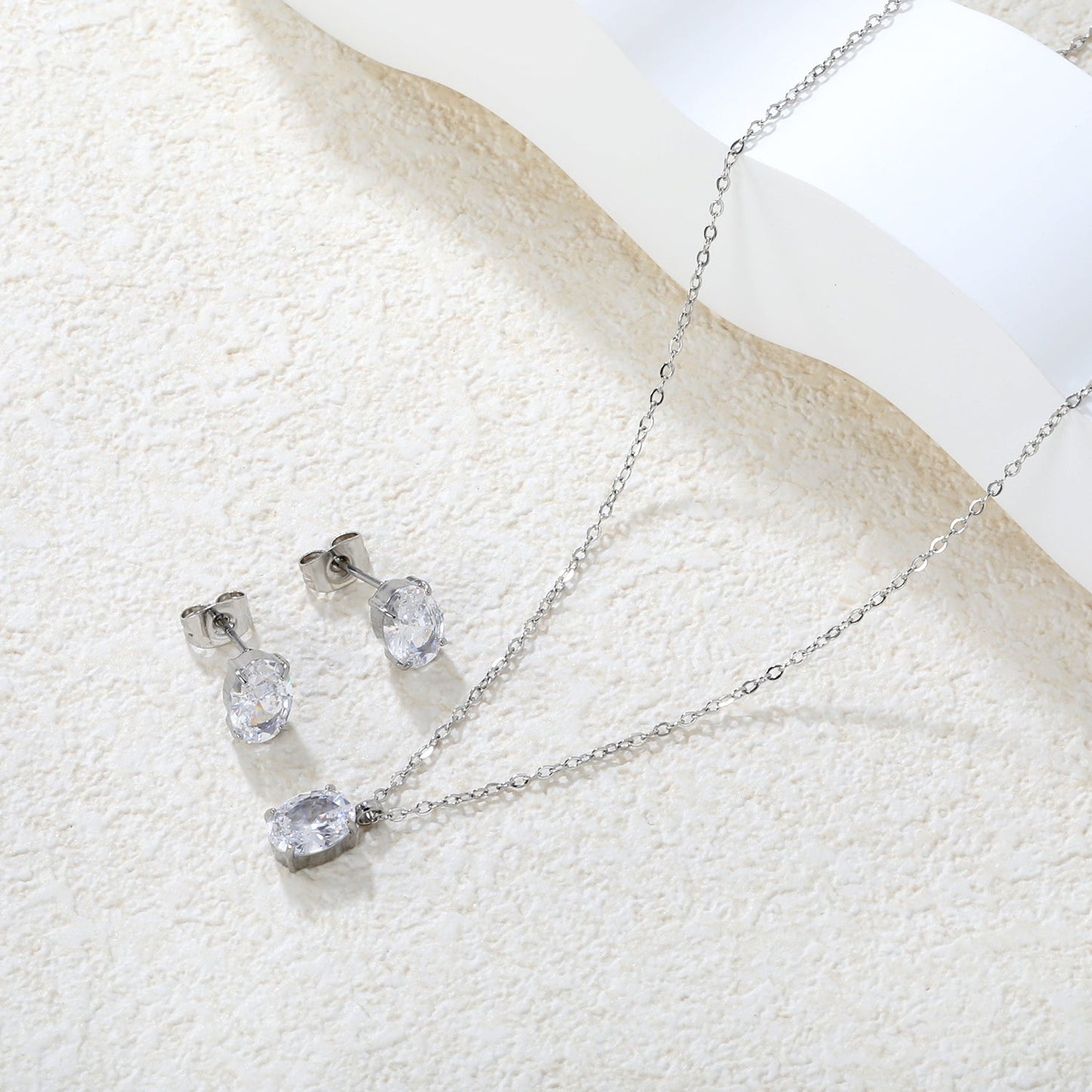 Oval Zirconia Set Gold/Steel Tone Studs: 6*8mm Pendant: 6*8mm 0.3ct Cross Chain 40+5cm + 6mm Round Tag asonjewelry