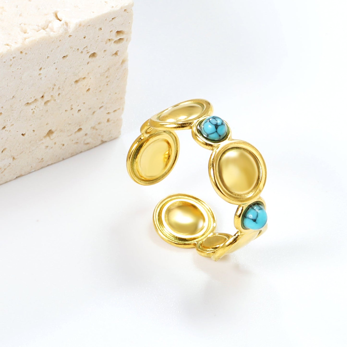 The ring consists of discs of various sizes and is set with 2 turquoise stones. asonjewelry