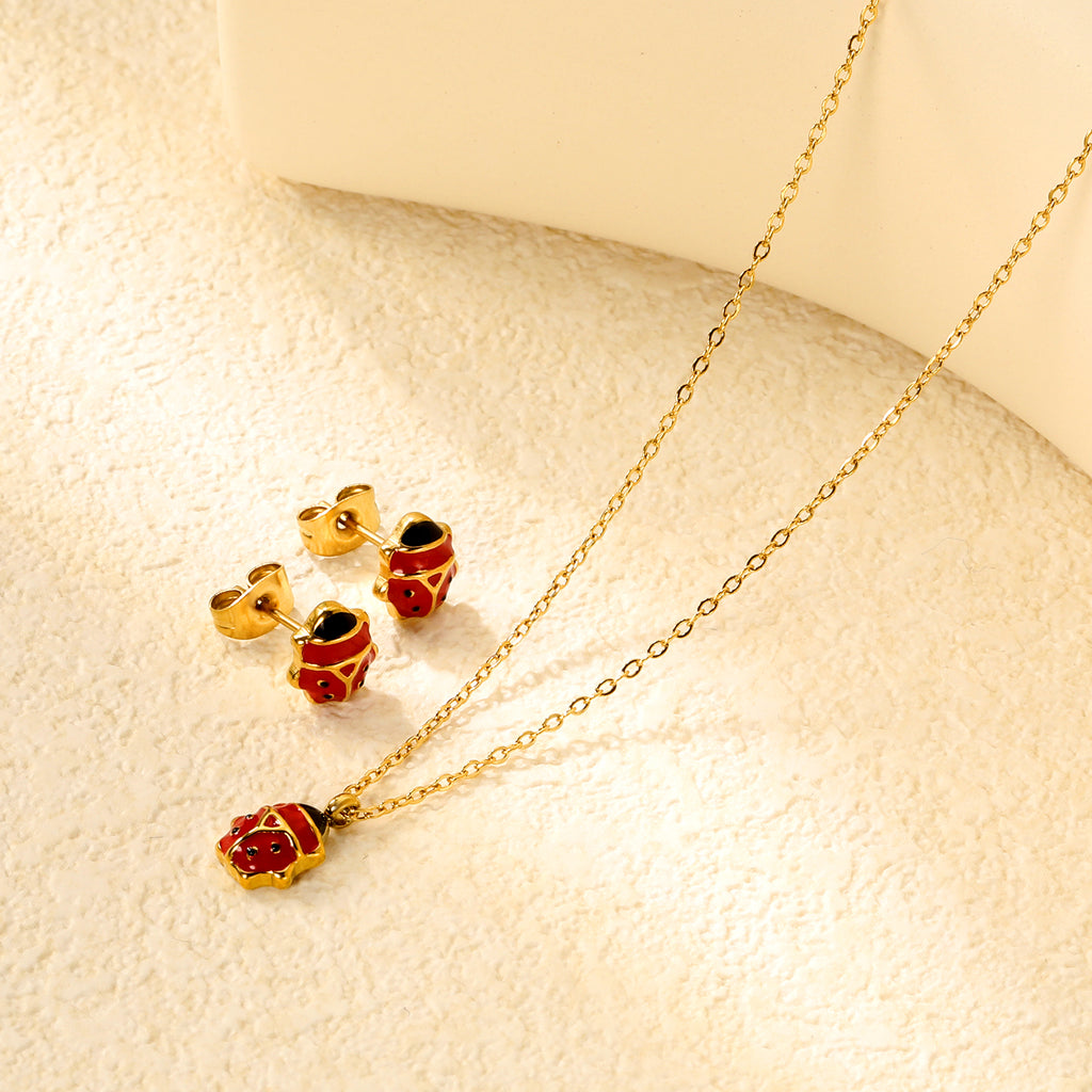 Seven star ladybug set Steel color/golden earrings: 7.3*8.2mm Pendant: 7.3*8.8mm0.3 Cross chain 40+5cm+6mm round plate