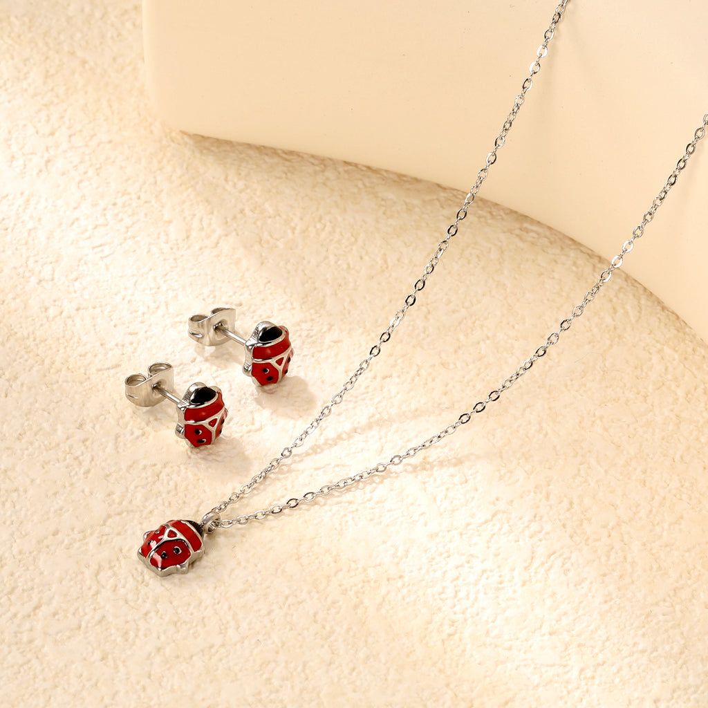 Seven star ladybug set Steel color/golden earrings: 7.3*8.2mm Pendant: 7.3*8.8mm0.3 Cross chain 40+5cm+6mm round plate