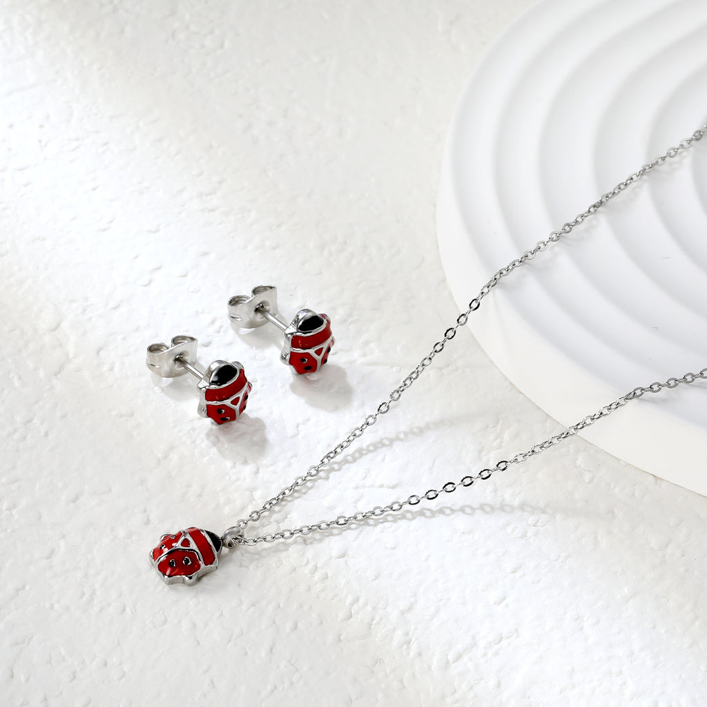 Seven star ladybug set Steel color/golden earrings: 7.3*8.2mm Pendant: 7.3*8.8mm0.3 Cross chain 40+5cm+6mm round plate