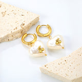 3x15mm circle with heart shaped white pearl + cherry stud earrings steel color / gold color