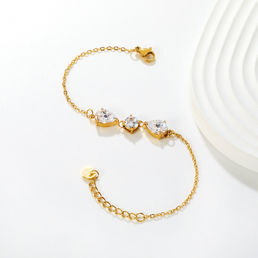 7*9mm pear-shaped white/blue diamonds, 7mm round white diamond, cross chain 18+3cm + 6mm round pendant tag, bracelet, gold