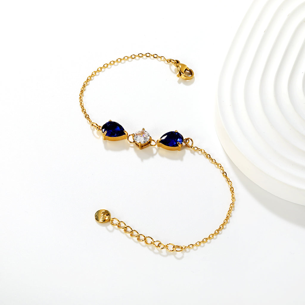 7*9mm pear-shaped white/blue diamonds, 7mm round white diamond, cross chain 18+3cm + 6mm round pendant tag, bracelet, gold