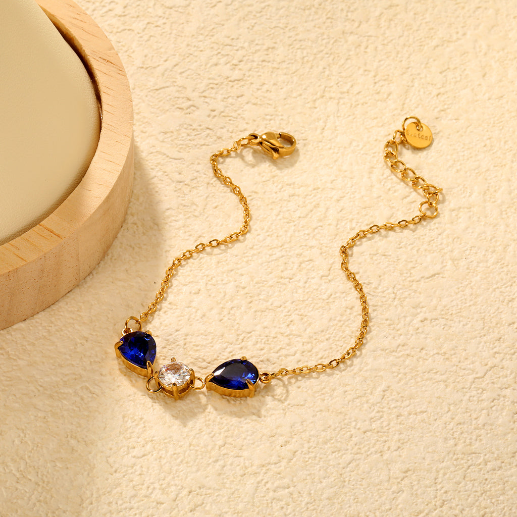 7*9mm pear-shaped white/blue diamonds, 7mm round white diamond, cross chain 18+3cm + 6mm round pendant tag, bracelet, gold