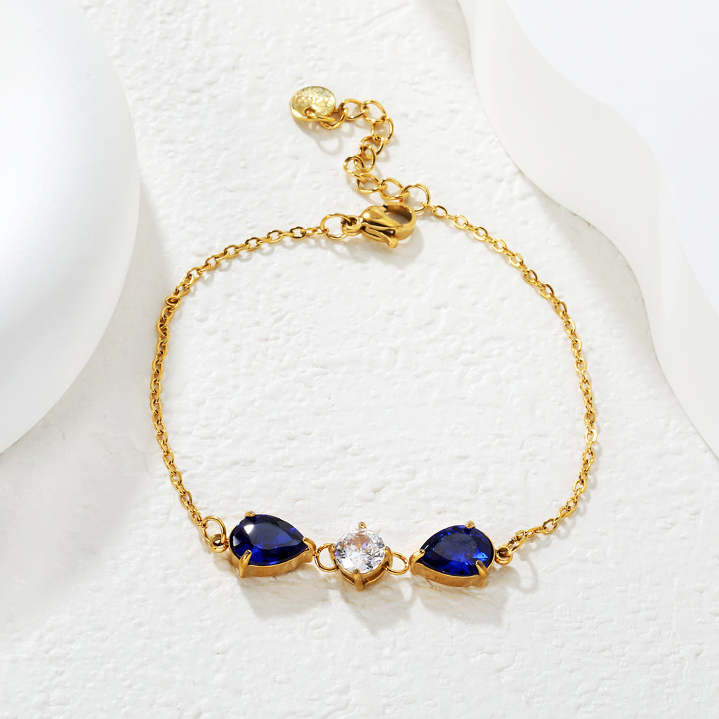 7*9mm pear-shaped white/blue diamonds, 7mm round white diamond, cross chain 18+3cm + 6mm round pendant tag, bracelet, gold