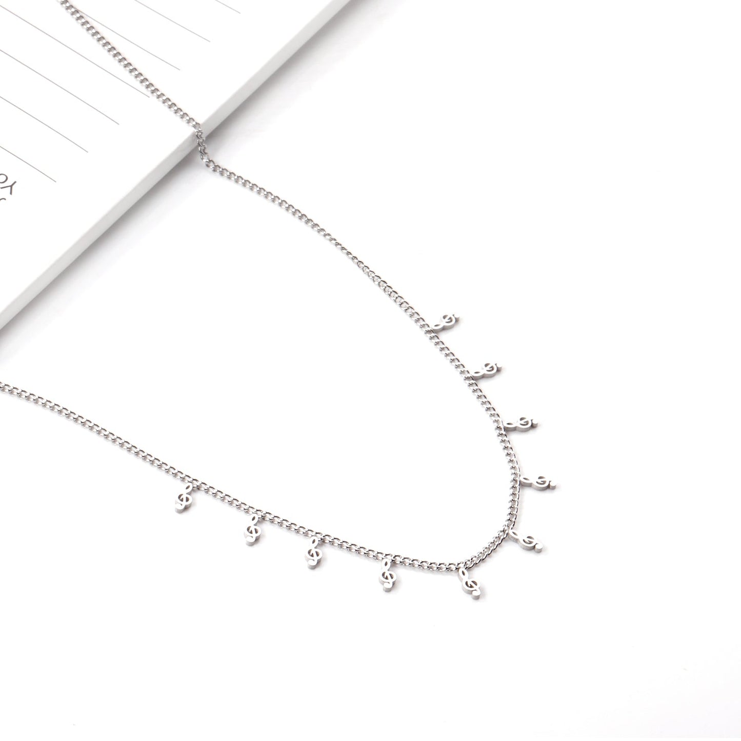0.4 Side chain 40+5cm welded 10 necklaces with 2.5x5mm musical notes in polished finish. asonjewelry