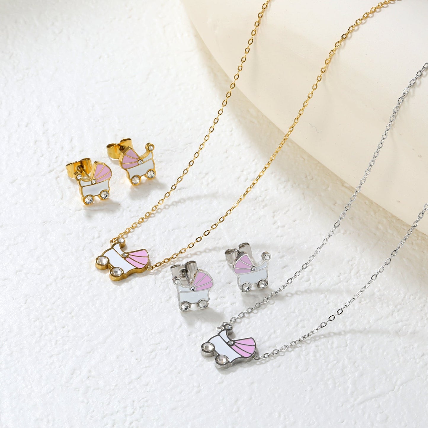 Pink and white rocking bed oil-dripping set with diamonds. Earrings: 9.8 x 10mm. Pendant: 10.5 x 12mm. 0.3mm cross chain 42+5cm + 6mm round pendant. Gold/steel color. asonjewelry