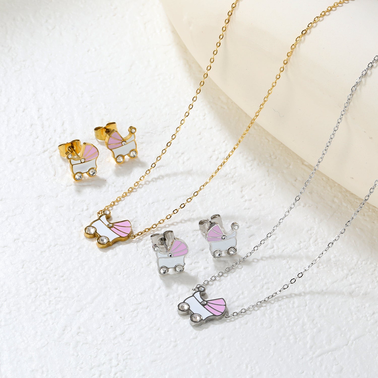 Pink and white rocking bed oil-dripping set with diamonds. Earrings: 9.8 x 10mm. Pendant: 10.5 x 12mm. 0.3mm cross chain 42+5cm + 6mm round pendant. Gold/steel color. asonjewelry