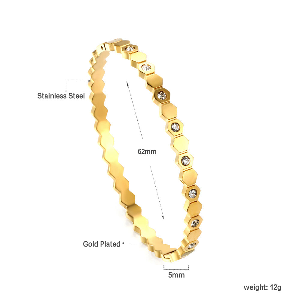Hard bracelet with diamonds strung together with small gold-colored discs asonjewelry