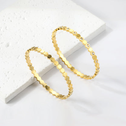 Hard bracelet with diamonds strung together with small gold-colored discs asonjewelry