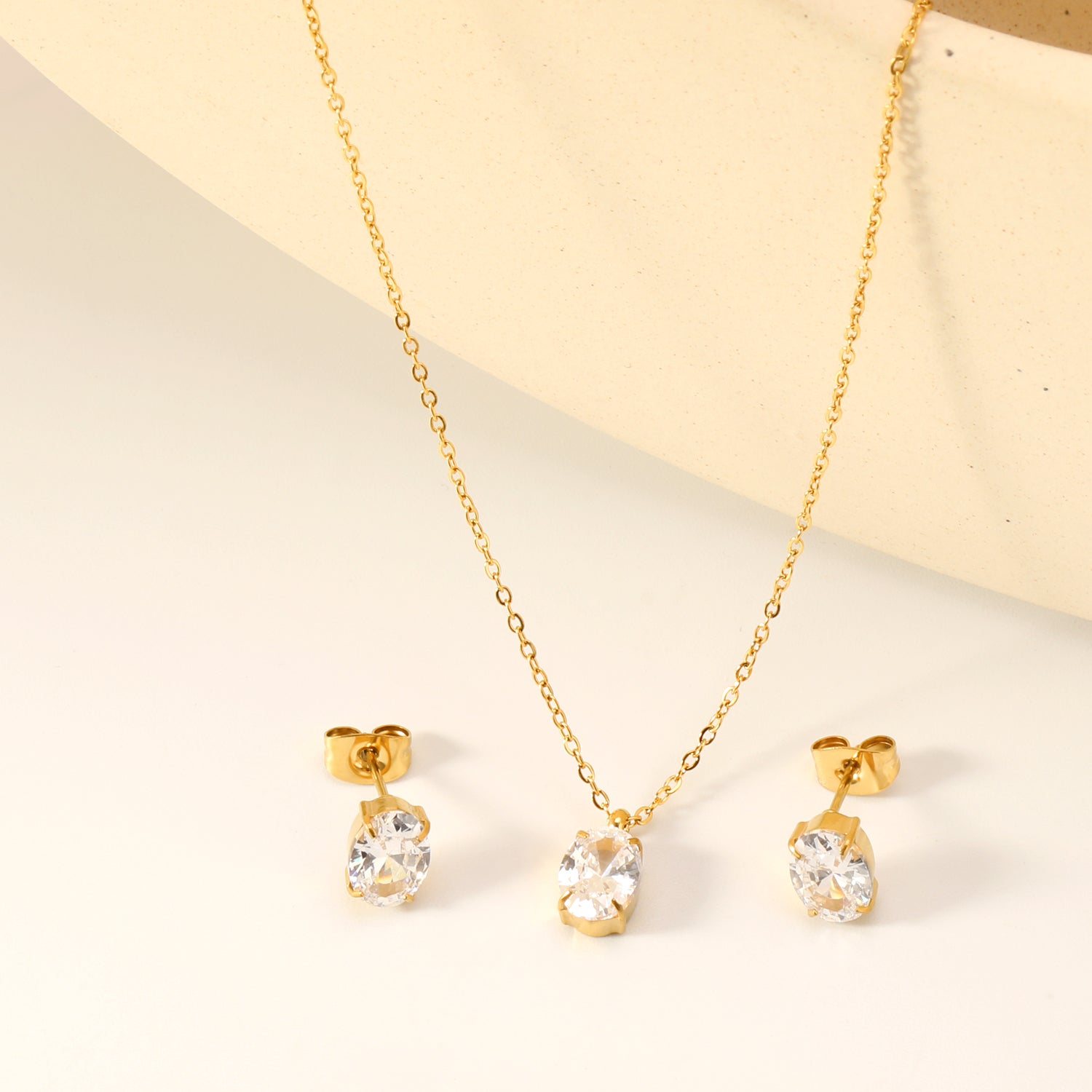 Oval white zirconium set Gold-colored earrings: 6*8mm Pendant: 6*8mm 0.3 cross chain *40+5cm+6mm round plate asonjewelry