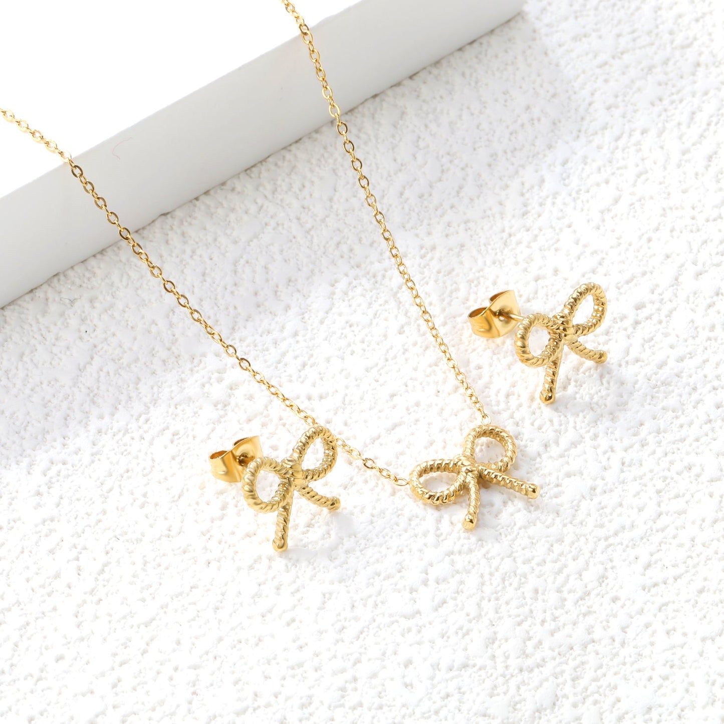 Bow Set Steel Color Earrings:13.2*11.2mm Necklace:13.2*11.2mm0.3 Cross Chain*40+5cm+6mm Round Plaque asonjewelry