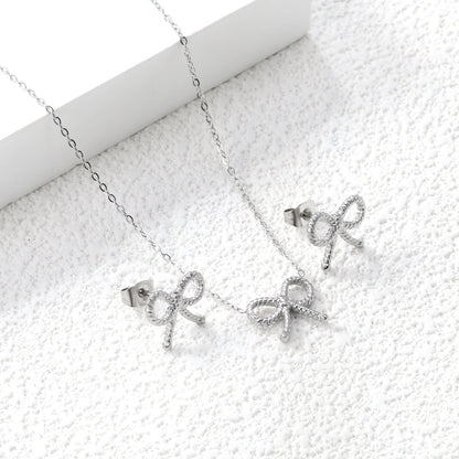 Bow Set Steel Color Earrings:13.2*11.2mm Necklace:13.2*11.2mm0.3 Cross Chain*40+5cm+6mm Round Plaque asonjewelry