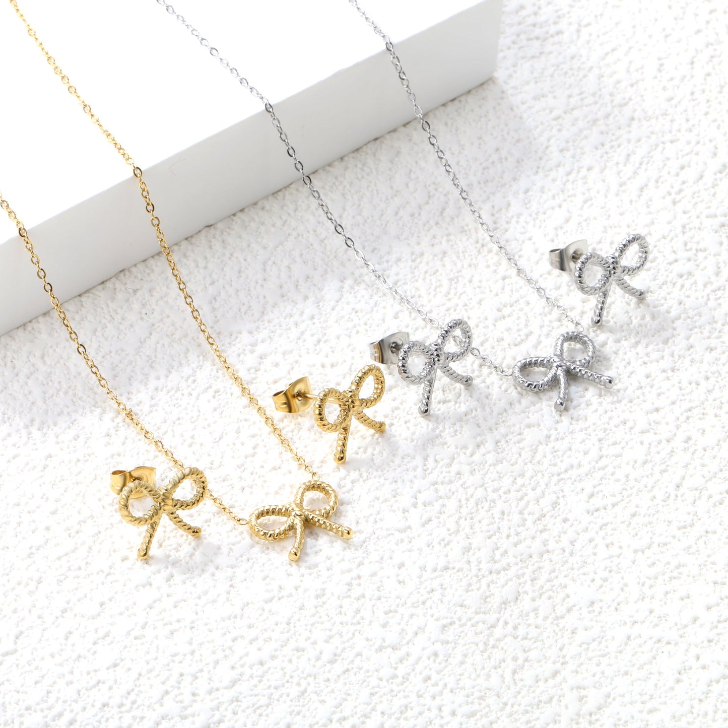 Bow Set Steel Color Earrings:13.2*11.2mm Necklace:13.2*11.2mm0.3 Cross Chain*40+5cm+6mm Round Plaque asonjewelry