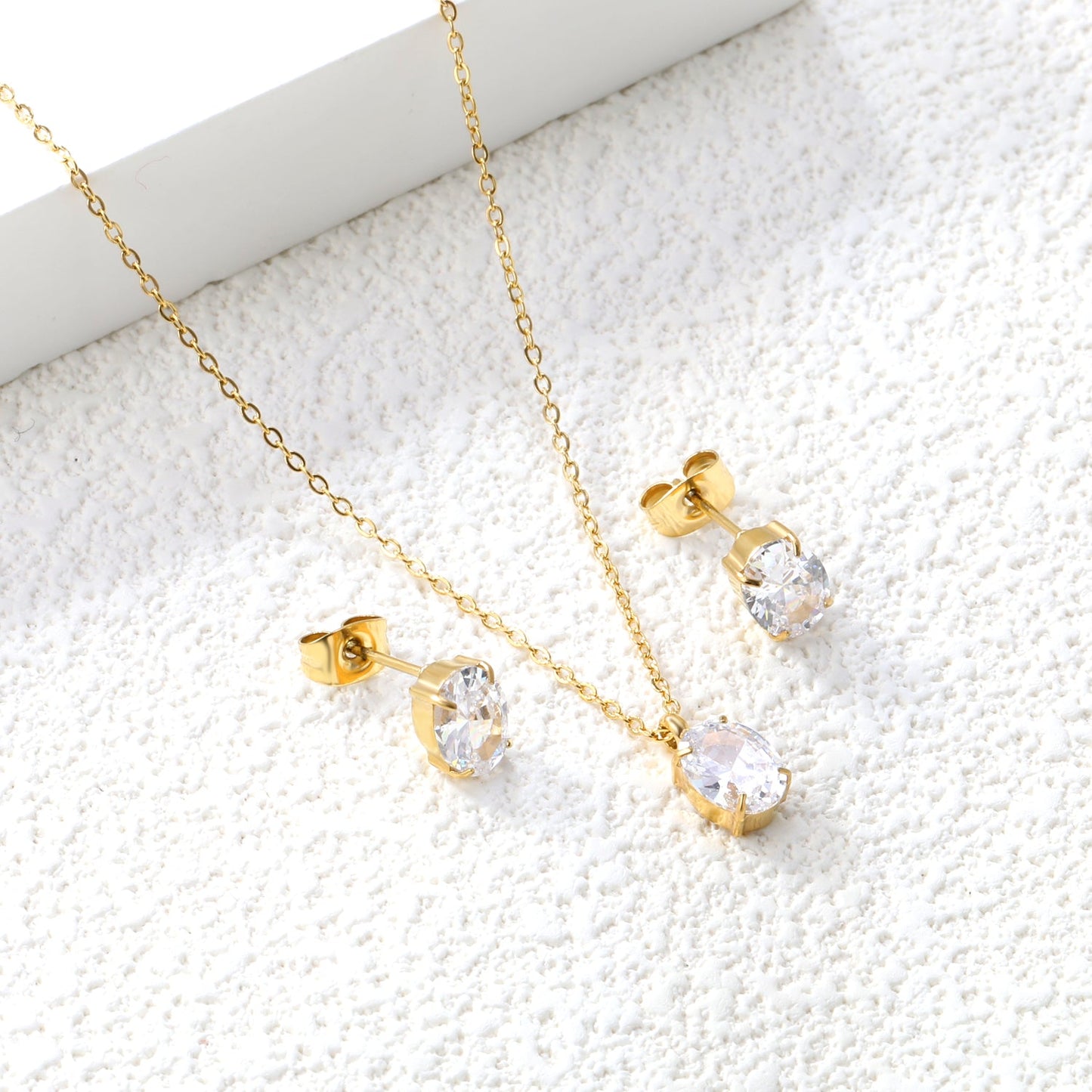 Oval Zirconia Set Gold/Steel Tone Studs: 6*8mm Pendant: 6*8mm 0.3ct Cross Chain 40+5cm + 6mm Round Tag asonjewelry