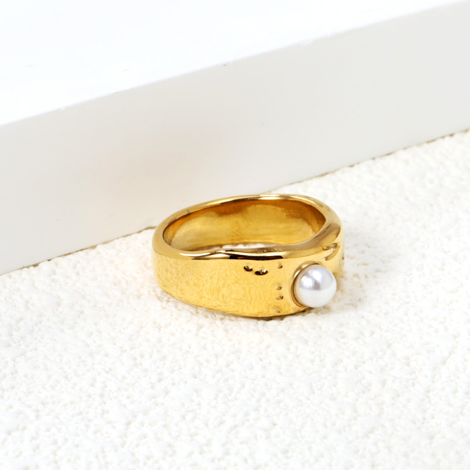 Gold-colored ring with a pearl surface asonjewelry