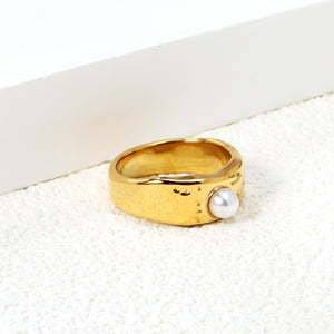 Gold-colored ring with a pearl surface