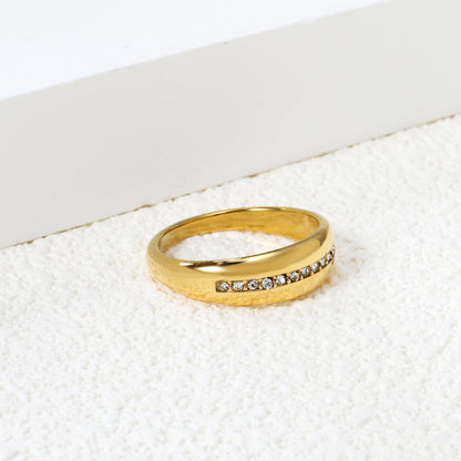 The center of the ring is set with a row of tiny diamonds asonjewelry