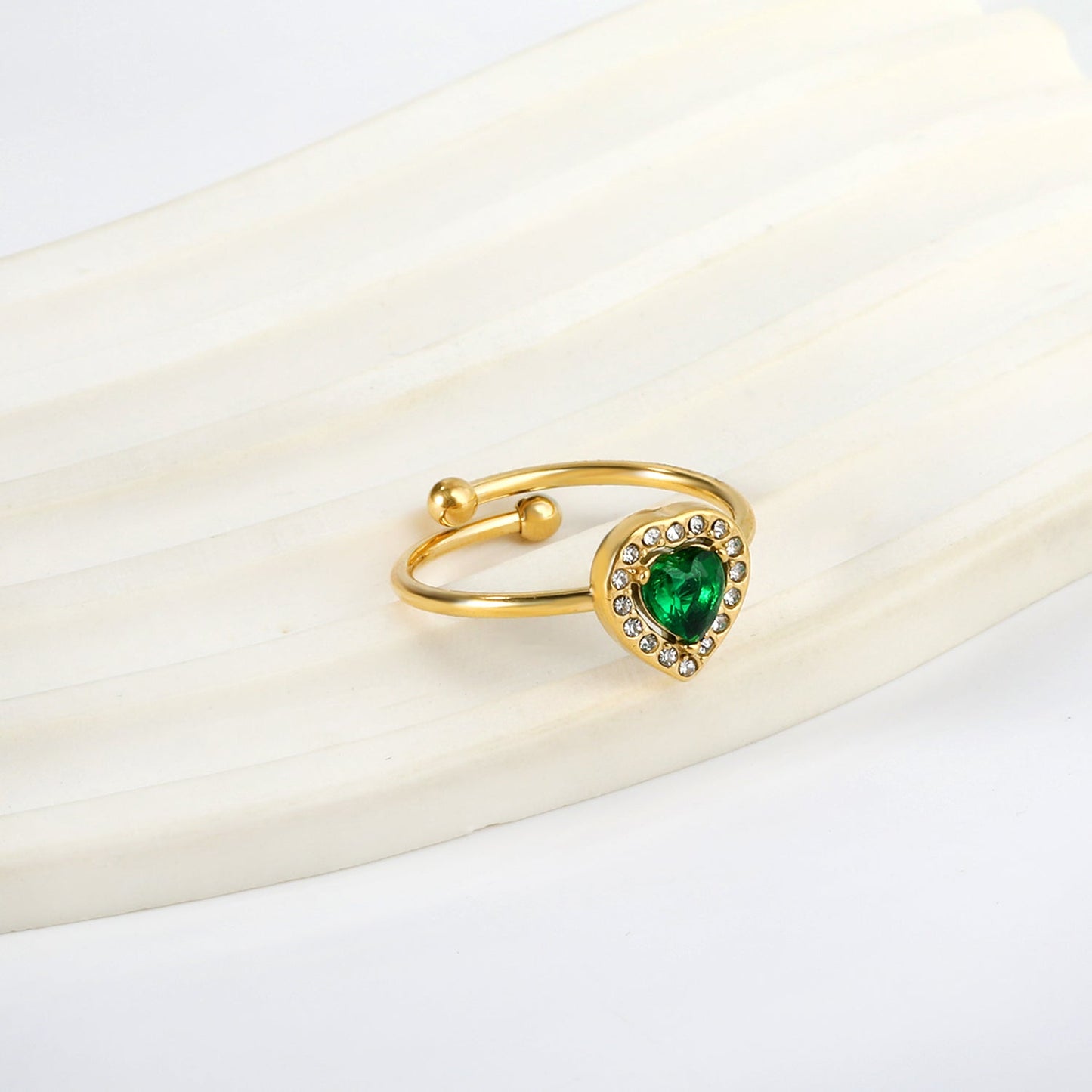 Heart shaped green diamond with small white diamonds ending in an open round bead ring asonjewelry
