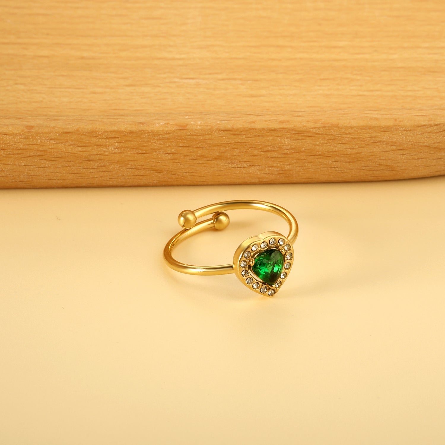 Heart shaped green diamond with small white diamonds ending in an open round bead ring asonjewelry