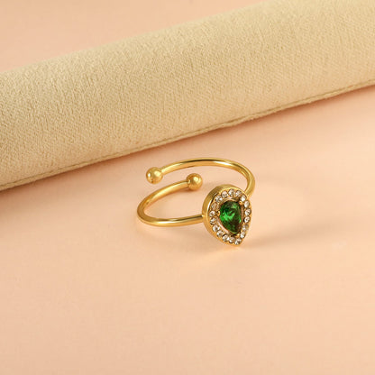 Teardrop green diamond with small white diamonds ending in an open round bead ring asonjewelry