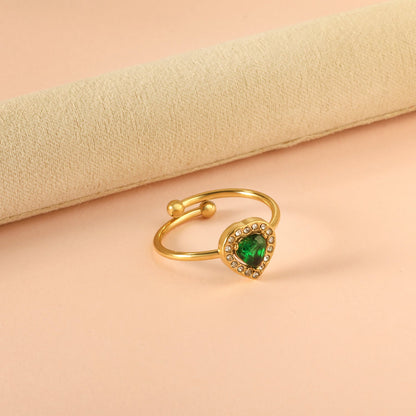 Heart shaped green diamond with small white diamonds ending in an open round bead ring asonjewelry