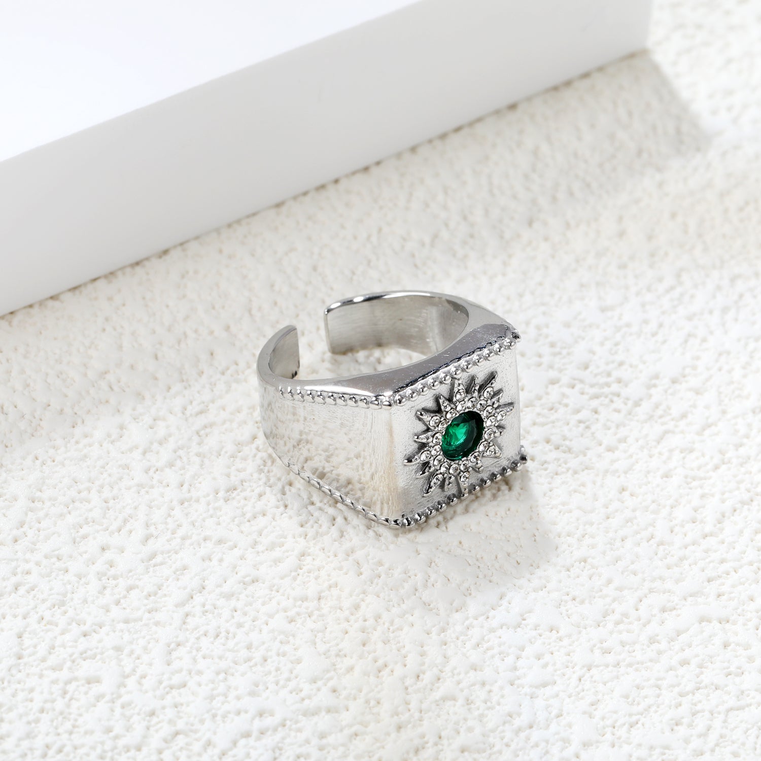 Exaggerated ring with green diamonds and engraved stamens. asonjewelry