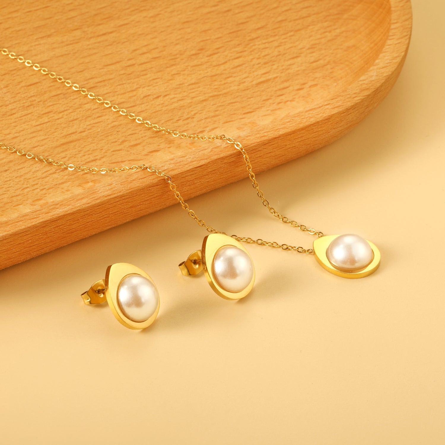 Teardrop shaped jewelry set with half white pearl steel color / gold asonjewelry