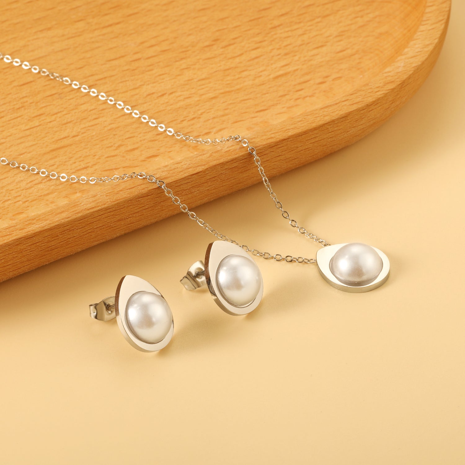 Teardrop shaped jewelry set with half white pearl steel color / gold asonjewelry