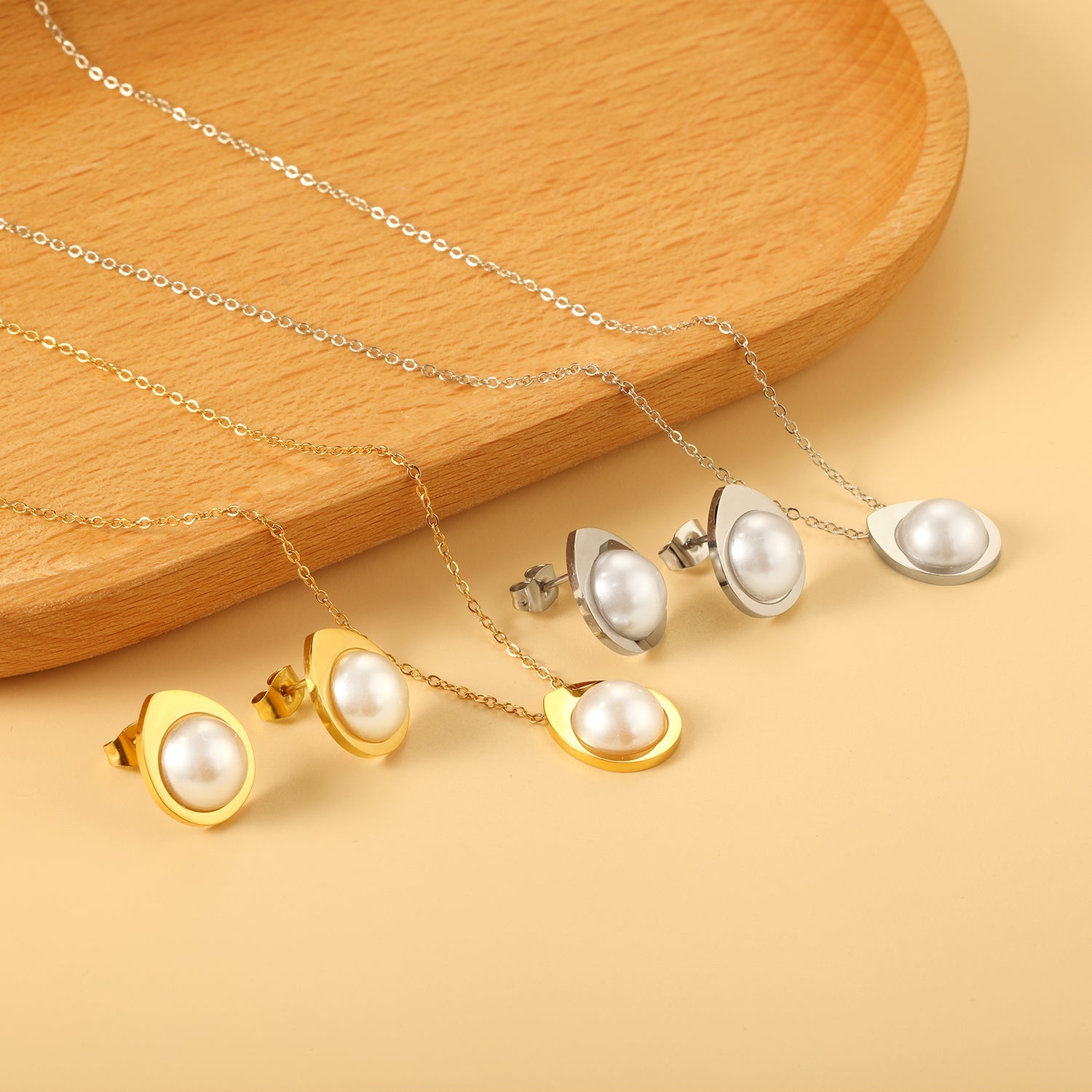 Teardrop shaped jewelry set with half white pearl steel color / gold asonjewelry