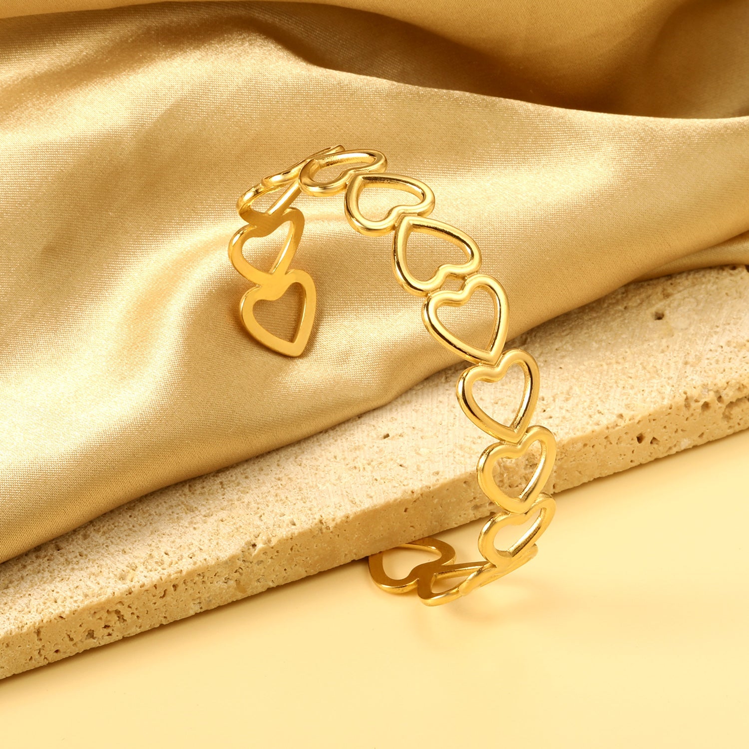 Bracelet with multiple openings in the shape of hollowed-out hearts linked together. asonjewelry