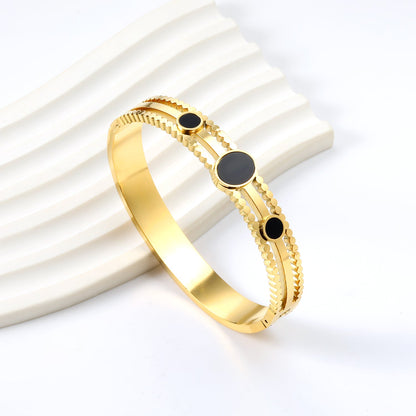 Chunky bracelet with three black oil-dripping circles asonjewelry