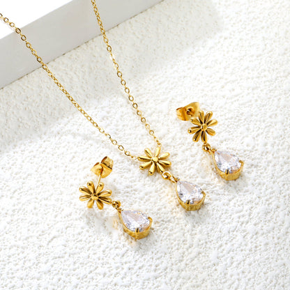 Flower + drop white diamond set Steel / Gold Earrings: 8.3mm flower + 6.2*10mm drop white diamond Pendant: 8.9mm flower + 6.2*10mm drop white diamond 0.3 Cross chain 42+5cm+6mm round plate asonjewelry