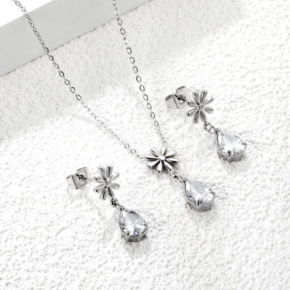 Flower + drop white diamond set Steel / Gold Earrings: 8.3mm flower + 6.2*10mm drop white diamond Pendant: 8.9mm flower + 6.2*10mm drop white diamond 0.3 Cross chain 42+5cm+6mm round plate asonjewelry