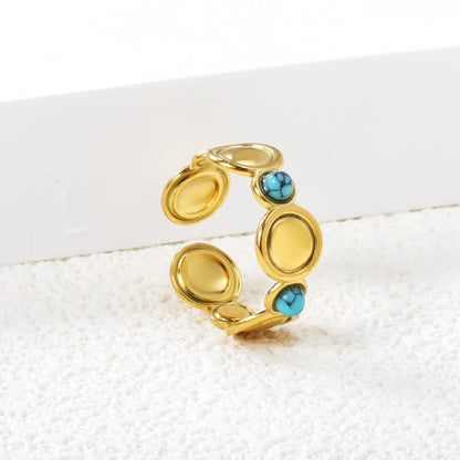 The ring consists of discs of various sizes and is set with 2 turquoise stones. asonjewelry